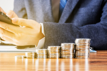 A pile of coins lined up in front of the merchant