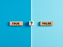 The Words True And False On Wooden Blocks With Question Mark Symbol.