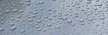 Raindrops On Black Hood Of Car Closeup