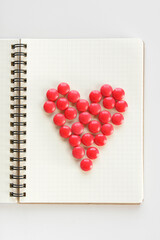 Chocolates arranged on a notebook to represent heart