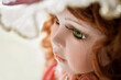 Close up porcelain doll face with green eyes