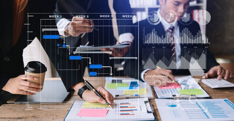 Businessman hand Project manager working and update tasks and Gantt chart scheduling virtual diagram.with smart phone, tablet and laptop in office.