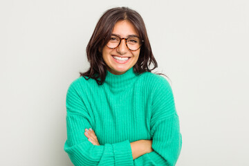 Wall Mural - Young Indian woman isolated on white background laughing and having fun.