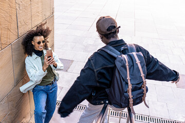 Generation z women having fun outdoor, young students and friends using smart phone to photograph happy and funny moments, social network app concept