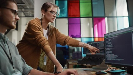 Poster - Male Programmer Showing Code on Desktop Computer to Female Lead Developer in Stylish Office Space. Caucasian Woman Helps Her Colleague With Useful Coding Hacks, Points at Erros on Display.