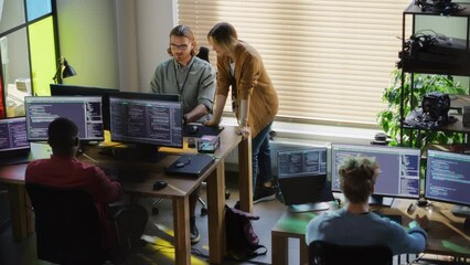 Poster - Creative Office: Diverse Colleagues Coding on Desktop Computers With Multiple Monitors. Female Project Manager Talks to Male Team Lead While Junior Developers Working on Mobile Application.