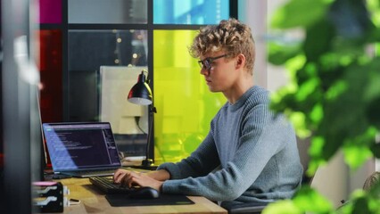 Poster - Side View of Male Data Science Intern Writing Lines Of Code on Desktop Computer In Stylish Office. Young Caucasian Man Solving Software Problems for Big Tech Company. Fututre Programmer Learns Coding.