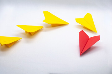 Wall Mural - Red paper plane origami leading yellow planes on white background. Leadership concept.