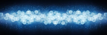 Winter Blue Background With Blurry Lights And Glitter. Concept Of Christmas, New Year And Holiday. Banner Defocused From The Light Of Garlands.
