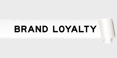 Ripped gray paper background that have word brand loyalty under torn part