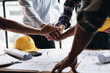 © PaeGAG - Businessman handshake with engineering in construction renovate building site. Engineer/architect inspection workplace for project.Teamwork construction engineer,business and architecture concept.