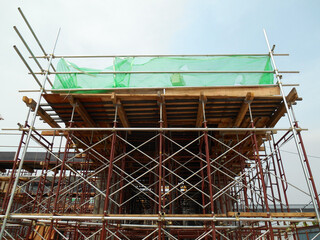 Wall Mural - JOHOR, MALAYSIA -APRIL 13, 2016: Scaffolding used as the temporary structure to support platform, form work and structure at the construction site. Also used it as a walking platform for workers. 
