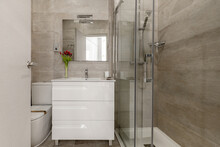 Bathroom With Square Mirror, White Chest Of Drawers And Glass Shower Stall