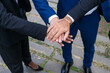 © ADDICTIVE STOCK - Crop businesspeople stacking hands on street