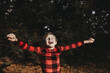 © Cavan Images - Young boy jumping for joy in Christmas pajamas outdoors