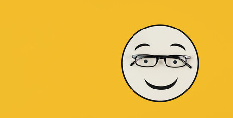Wall Mural - Head with a smiling face and eyeglasses, mental health concept, positive mindset, support and evaluation symbol
