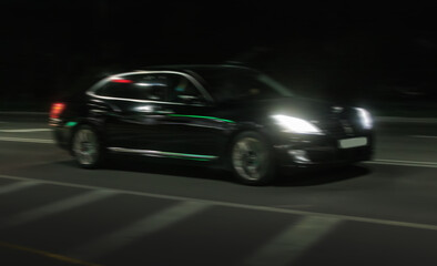 Wall Mural - black car rushes along the night road