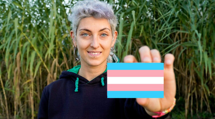 non-binary person claims gender identity with a transgender flag