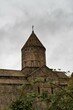 © Dmirii - Armenia, Tatev, September 2022. View of the temple through the blackberry branches.