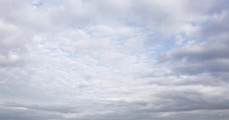Wall Mural - fast moving colored clouds in blue sky aerial time lapse. natural cloudscape timelapse background in