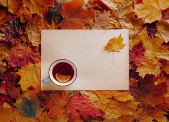 Wall Mural - Autumn flat lay - fall leaves, lemon tea cup, blank craft leaf