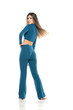 © vladimirfloyd - young modern barefeet smiling woman in blue pants and blouse posing on white studio background. rear, back view