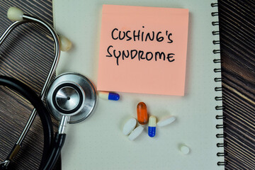 Concept of Cushing's Syndrome write on sticky notes with stethoscope isolated on Wooden Table.
