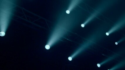 Poster - Flashing spotlights on dark stage. Stock footage. Flashing spotlights on stage for show. Spotlights blink in dark of theater