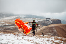 Paraglider With Parachute In The Mountains In Winter