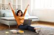 © Prostock-studio - Happy Middle Eastern Female Student Celebrating Success With Laptop At Home