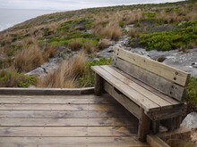 Wooden Bench On The Cliff With Moody Cloud