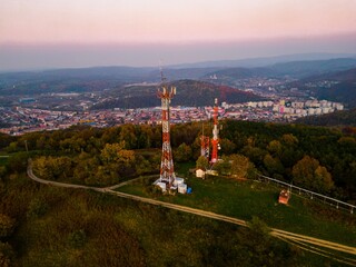 Aerial view of telecommunication tower situated on a hill top, with many cellular antennas which transmits 3G, 4G and 5G signal to phones and other terminals