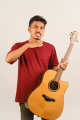 Wall Mural - Portrait of Young Asian man in red t-shirt with an acoustic guitar isolated on white background