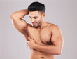 Muscular man, skincare and strong model, wellness and confident with studio background. Happy male, sexy and fitness for body healthy care, smooth and glowing skin for bodybuilding and flex muscle