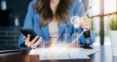 Aufkleber - Businesswoman analyzes profitability of working company with digital virtual screen graphics. 2023 Planning invest indicators long-term. positive of businessman calculates financial data investments.
