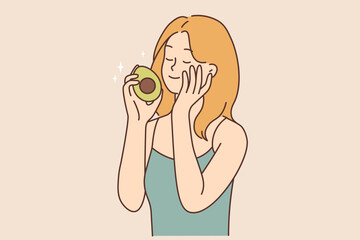 Sticker - Smiling woman touch skin hold avocado in hands 