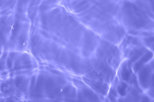 Defocus Blurred Transparent Purple Colored Clear Calm Water Surface Texture With Splash, Bubble. Shining Purple Water Ripple Background. Surface Of Water In Swimming Pool. Purple Bubble Water Shine.
