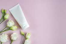 Moisturizer Hand Cream White Plastic Tube Mockup On Pink Trandy Background With Eustoma Flowers. Blank Skin Care Beauty Product Packaging