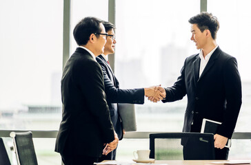 Wall Mural - Image two business partner meeting successful handshake together with success join congratulation good deal contract in modern office.Partnership approval and teamwork concept