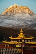 Scenic shot of the Tagong temple and Yala mountain covered in snow in Sichuan, China