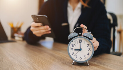 Wall Mural - alarm clock on the desk. business working in modern office building or home at night using laptop..