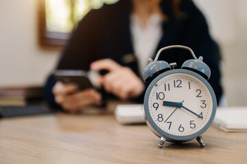 Wall Mural - alarm clock on the desk. business working in modern office building or home at night using laptop..