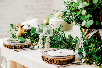 Wedding. Decor. Serving. Artwork. Banquet table for two served and decorated with flowers 