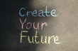 © New Africa - Phrase Create Your Future written on asphalt, top view