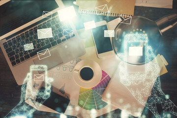 Poster - Envelop hologram drawing over computer on the desktop background. Top view. Double exposure. Technology concept.
