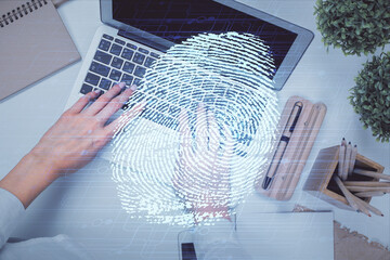 Poster - Double exposure of woman hands working on computer and fingerprint hologram drawing. Top View. Digital Security concept.