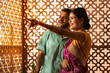 © IndiaPix - Portrait of Gujrati couple looking outside and pointing