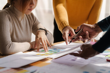 Wall Mural - a ux design team is a confluence of user research, ux, ui design with layout paper on desk.