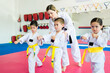 Active kids practicing karate with a martial arts trainer