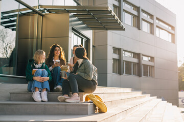 group of female college students outdoor in campus talking and smiling